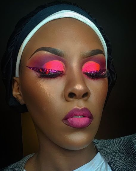 Model wearing Amerindian Paradise eyeshadow palette in a bold red eyeshadow look with high pigment payoff.