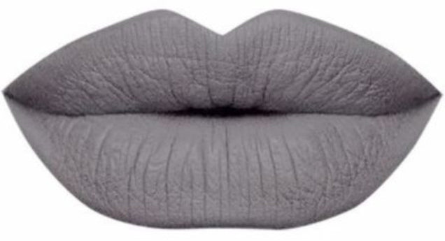 A blue gray stone age liquid lipstick swatch showing high-intensity color for bold makeup lovers.
