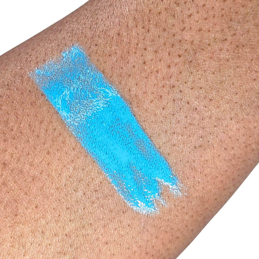 Swatch showing soft Blue liquid lipstick with buildable medium coverage and a soft semi-matte finish. 