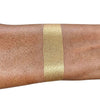 Caribe loose shimmer powder swatch showing radiant gold highlighter for face and body.