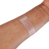 Caribe loose shimmer powder swatch showing radiant pink highlighter for face and body.