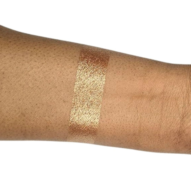Caribe loose shimmer powder swatch showing radiant bronze highlighter for face and body.