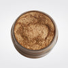 Caribe loose shimmer powder open jar showing radiant bronze highlighter for face and body.