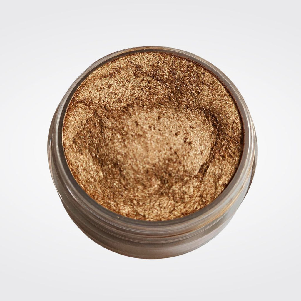 Caribe loose shimmer powder open jar showing radiant bronze highlighter for face and body.