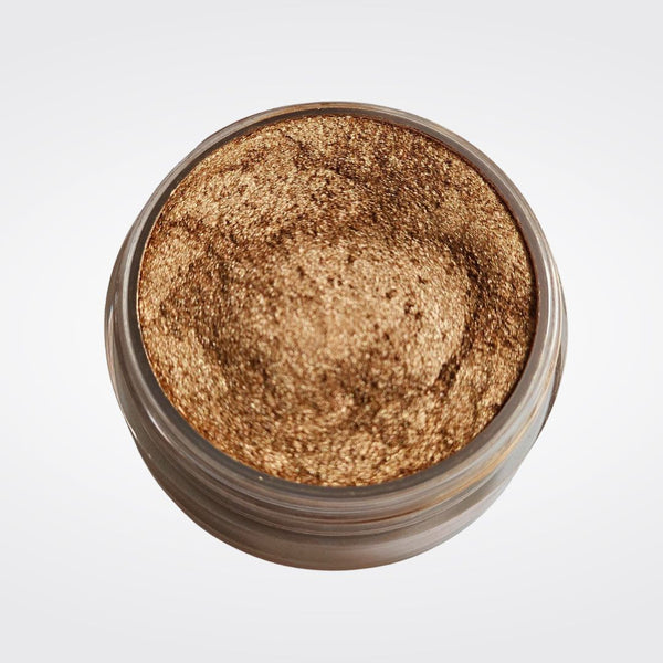 Caribe loose shimmer powder open jar showing radiant bronze highlighter for face and body.