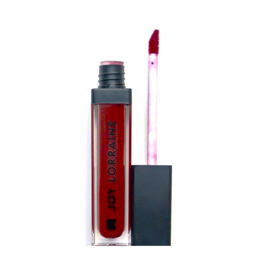 Cool red liquid matte lipstick with high pigment and a smooth transfer-resistant finish designed to complement melanin-rich skin tones.