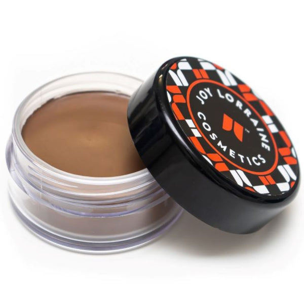 Open jar of lightweight, buildable cream foundation showing dark shade with a smooth, even-tone finish for a radiant glow.