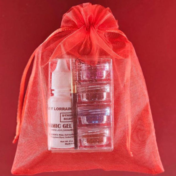 Four cosmetic-grade loose glitters, vegan glitter makeup glue, and mini brush for eyes, face, and body makeup in a red sheer drawstring bag.