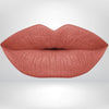 Close-up of lips in rose brown shade with long-wear, smudge-resistant matte finish.