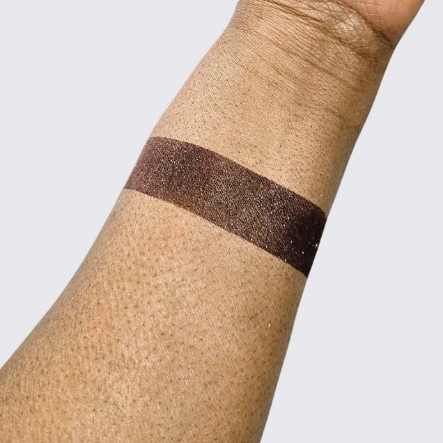 Swatch of loose wine shimmer eyeshadow with ultrafine pigments for radiant, buildable color payoff. 