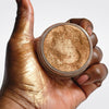 Loose Bronze Highlighter - TobaGLOW  in open jar with hand swatch showing bronze shimmer highlighter makeup for face and body. 


A bronze shimmer powder for face and body. Finely milled, lightweight formula delivers a luminous, radiant glow for all skin tones.