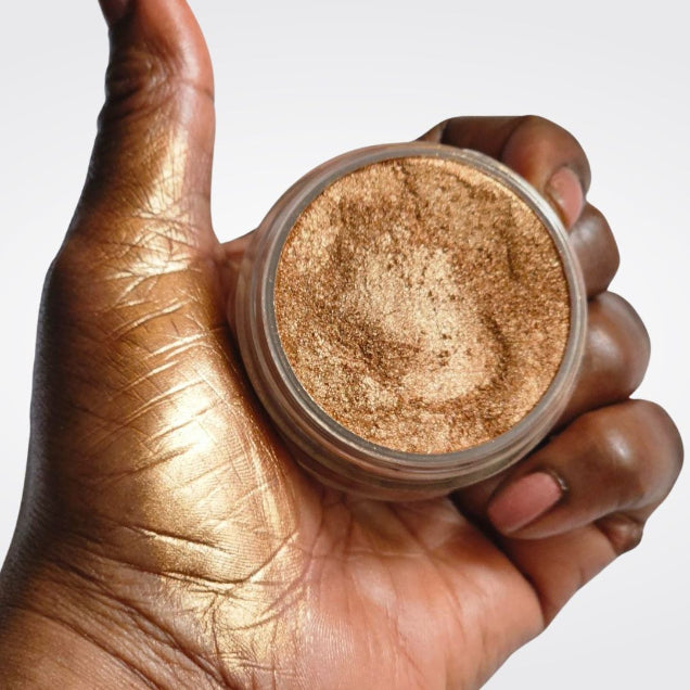 Loose Bronze Highlighter - TobaGLOW  in open jar with hand swatch showing bronze shimmer highlighter makeup for face and body. 


A bronze shimmer powder for face and body. Finely milled, lightweight formula delivers a luminous, radiant glow for all skin tones.