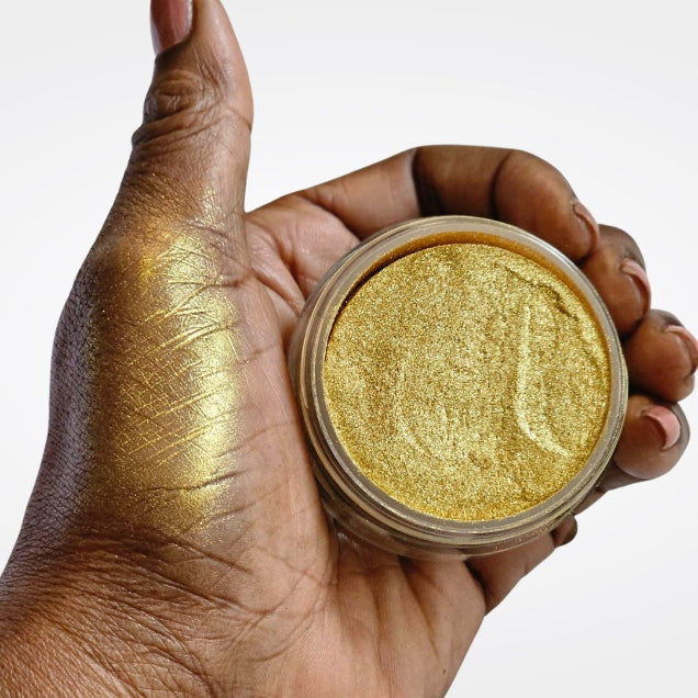 Loose Gold Highlighter - JuliemanGLOW in open jar with hand swatch showing gold shimmer highlighter makeup for face and body. 