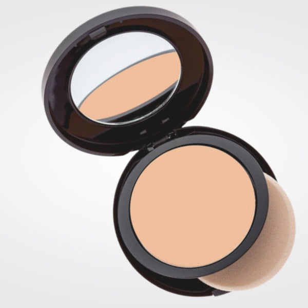 Open compact with medium almond powder foundation with sponge applicator in Caramel shade. 
