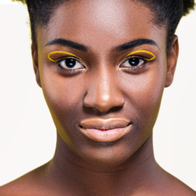 Peach liquid matte lipstick on model with high pigment and a smooth, transfer-resistant finish designed to complement melanin-rich skin tones. 