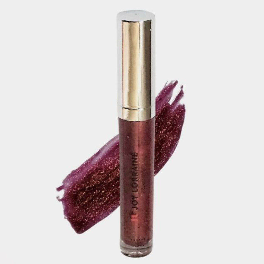 Plum vegan lip gloss with high-shine, non-sticky shimmer finish shown with swatch designed to complement melanin-rich skin tones.
