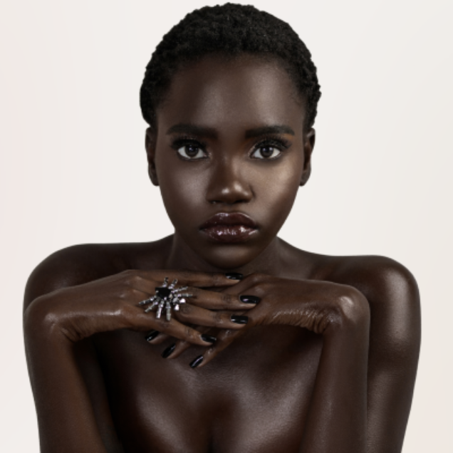 Model wearing Chocolate Lip Gloss - TOCO. A high shine, non-sticky shimmer gloss that hydrates, smooths, and visibly plumps lips.