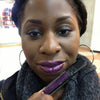 Woman wearing Time Warp Lip Gloss; a non-sticky purple glitter lip gloss
