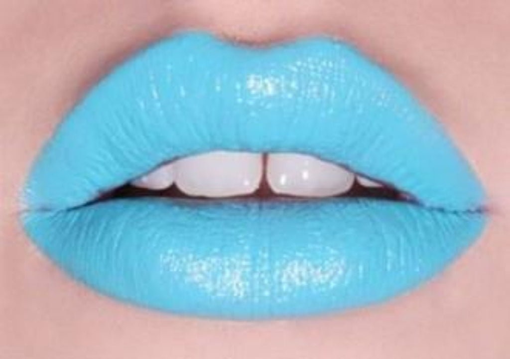 Lip swatch showing blue liquid lipstick over matte blue lipstick for editorial makeup look.