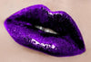 Swatch of Time Warp Lip Gloss on lips; a stunning purple shimmering lip gloss.